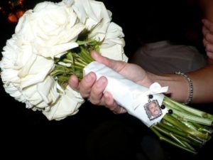 White rose wedding bouquet with attached small picture frame charm