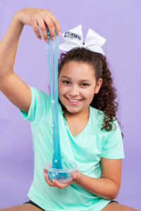 slime, purple, teal aqua, turquoise, pink, squishies, squishy's, bows, cheerleader, curly hair, orange, white bow, turquoise shirt, tween girl, 11 years old, fun, silly
