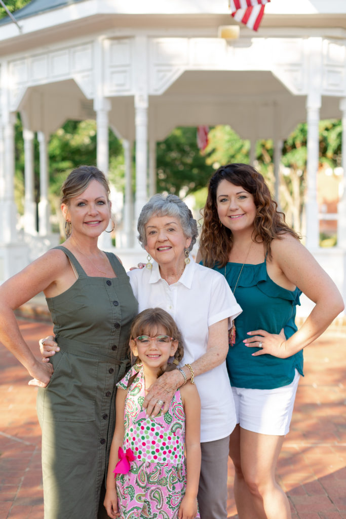 Four generations of women in a family pose in downtown Canton, GA