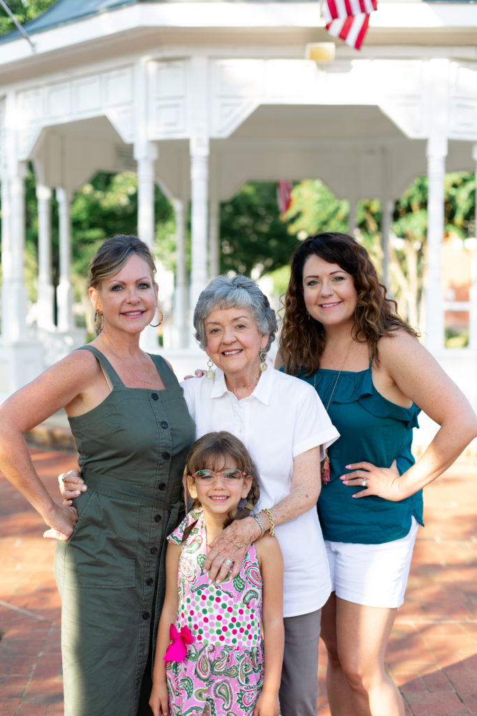 Four generations of women in a family pose in downtown Canton, GA