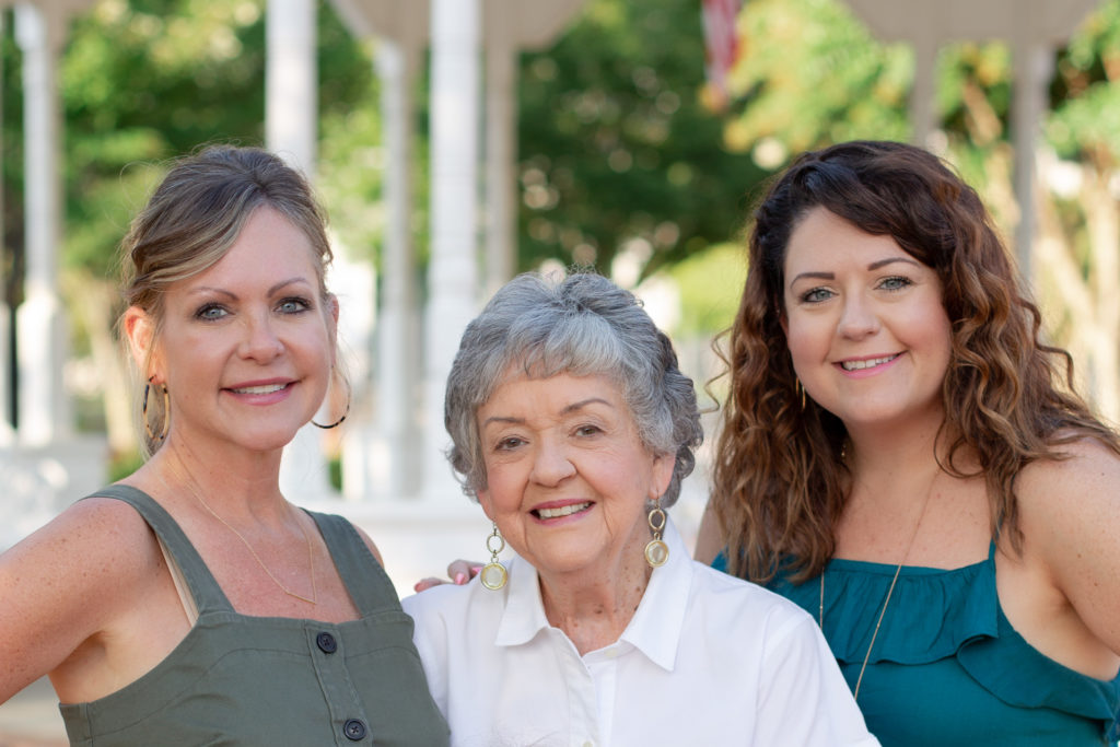 Three generations of women in a family pose in downtown Canton, GA