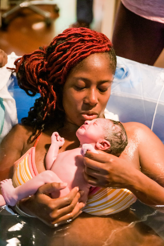New mother holds newborn in birthing pool at North Fulton