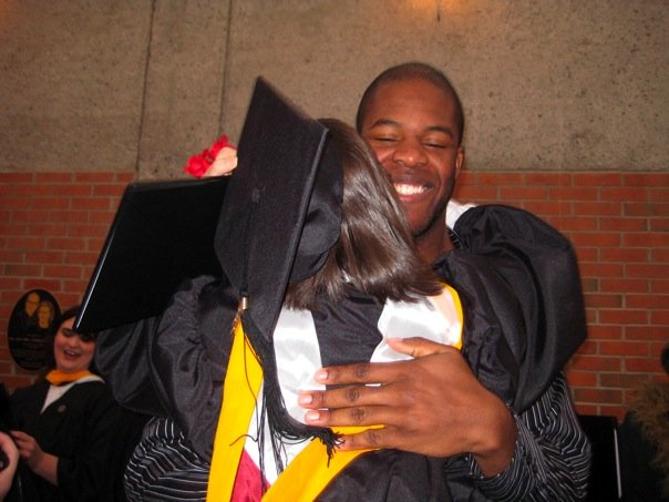 Desmond picks Jill up and hugs her on graduation from Lee University
